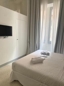 a bedroom with a bed with towels on it at Veneto Serviced Apartment by SupaStays in Rome