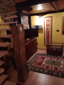 ein Wohnzimmer mit einem TV und einem Holzschrank in der Unterkunft La Mimosa di Bellano in Bellano
