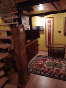 a living room with a tv and a wooden cabinet at La Mimosa di Bellano in Bellano