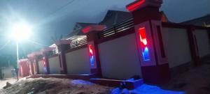 a building with red and blue lights in the snow at KOFFY STAR GUEST HOUSE in Kumasi