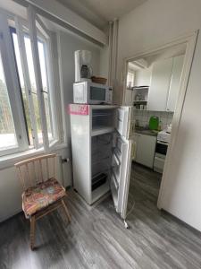 a small kitchen with a chair and a microwave at Студия in Kouvola