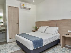 Postel nebo postele na pokoji v ubytování Stanza Hotel Medellin + 22 fotografií