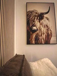 a picture of a bull hanging on a wall at 100m E-Ladestation - max 4 pers - Düsseldorf - Ruhrgebiet - Pilgerstätte in Velbert