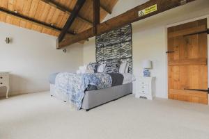 a bedroom with a bed and a wooden door at Newmarket Gem 5-Bedroom Home with Game Room and Cozy Spaces in Brinkley +118 photos