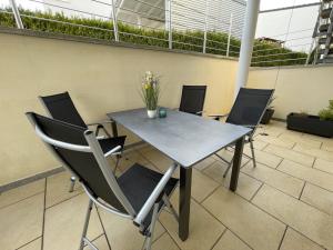 a table and chairs with flowers on a patio at Lieblingsplatz in Pfullendorf