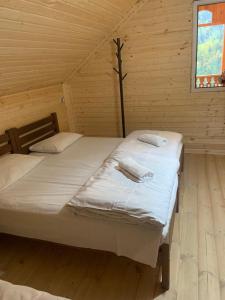 a bedroom with two beds in a wooden cabin at Vichnashi in Mestia