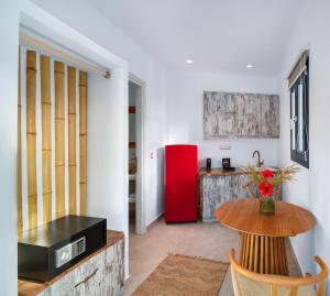 a living room with a table and a red refrigerator at Electra Suites & Spa in Perivolos