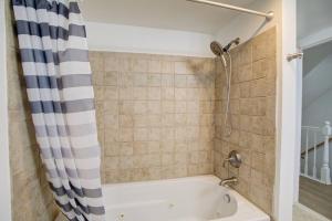 a bath tub with a shower curtain in a bathroom at Cozy Lux 3bd House Heart of Fishtown Sleeps 8 in Philadelphia