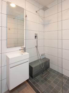 a white bathroom with a sink and a shower at CAPE TOWN - MOUILLE POINT - SEA VIEW APARTMENT in Cape Town