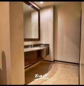 a bathroom with a sink and a mirror at Hotel Dali in Reynosa