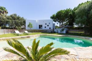 a villa with a swimming pool and a house at CASA LUZ. Casas Los Elementos. in Zahora