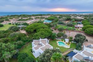 an aerial view of a large white house with a pool at CASA LUZ. Casas Los Elementos. in Zahora