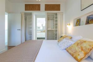 a bedroom with a large white bed with two pillows at CASA LUZ. Casas Los Elementos. in Zahora +24 photos