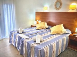 a hotel room with a large bed with towels on it at Hotel Montecarlo in Llafranc