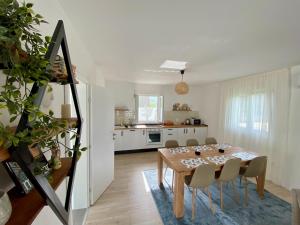 a kitchen and dining room with a table and chairs at Vestovis Holiday House in Mostar
