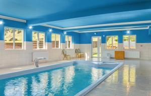 a swimming pool in a house with blue ceilings at Pensiune Domeniul Stanca in Vatra Dornei
