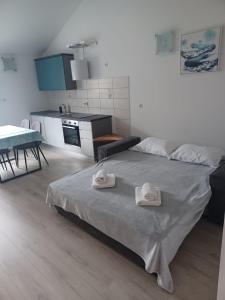 ein Schlafzimmer mit einem Bett mit zwei Handtüchern darauf in der Unterkunft Apartment Roza in Cres