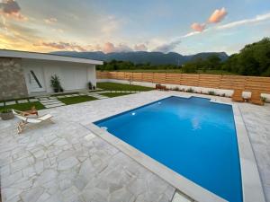 a swimming pool in the middle of a yard at Vestovis Holiday House in Mostar
