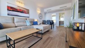 a living room with a couch and a table at Skyscraper apartment with panoramic views - floor 38 in Benidorm