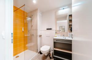 a bathroom with a toilet and a shower and a sink at Beelodge Hotel Blois Centre in Blois +90 photos