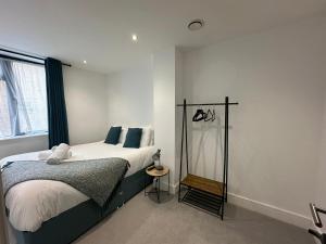 a bedroom with a bed and a window at Kings Gate House DH ApartHotels in Peterborough