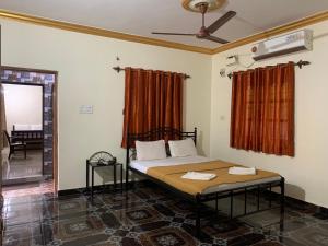 a bedroom with a bed with two towels on it at Casa De Calangute Beach in Calangute
