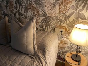 a bedroom with a bed with a pillow and a lamp at Apartamento El mirador de Olite in Olite