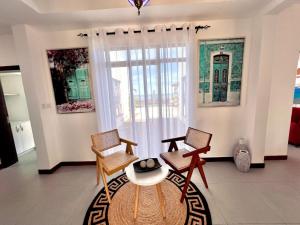 a living room with two chairs and a table at The Casa Sultan in Kikambala