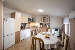 a kitchen with a table with a bowl of fruit on it at Apartman Kesten in Lovran