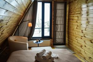 a bedroom with a bed and a window at AMO in Gudauri