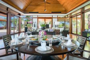 a dining room with a large table and chairs at Villa 29 Montebello Andara Resort Villas in Kamala Beach