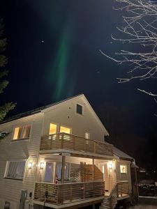 a house with the aurora in the sky at Cozy apartment in Tromsø / Tromsdalen in Tromsø