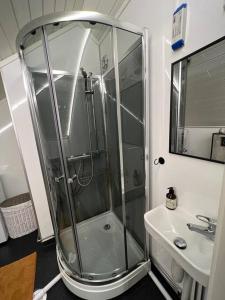 a bathroom with a shower and a sink at Cozy apartment in Tromsø / Tromsdalen in Tromsø
