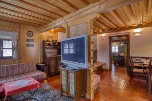 a living room with a large flat screen tv at Chalet Kupljenik Near Bled Lake in Bohinjska Bela