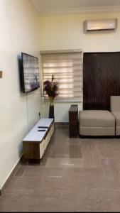 a living room with a couch and a table at LA VIVA AIRBNB in Abuja