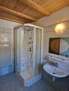 a bathroom with a shower and a sink at Attico in Centro: Relax&Comfort in Baselga di Pinè