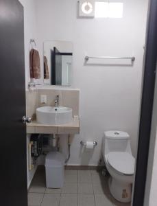 a bathroom with a sink and a toilet at Hermosos Departamentos in Cozumel