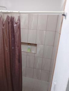 a shower with a shower curtain in a bathroom at Hermosos Departamentos in Cozumel