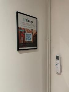 a picture hanging on a wall with a ipod at L'Étage, hypercentre Toulousain, Climatisé in Toulouse
