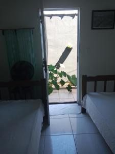 a room with an open door with a plant outside at Casa da Ruthemar-Suite para 2 pessoas in São Sebastião