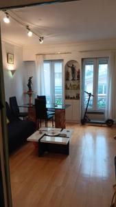 ein Wohnzimmer mit einem Sofa und einem Tisch in der Unterkunft Apart calmo em paris jourdain in Paris