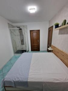 a bedroom with a large bed and a mirror at Znc Holiday House in Cetara