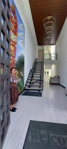 kobieta stojąca w budynku z malowidłem na ścianie w obiekcie The Madevelyn in Atitlán w mieście Panajachel