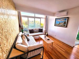 a living room with a couch and a large window at Peers Guest House in Cascais