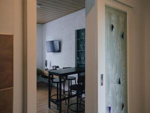 a dining room with a black table and chairs at Serenity Ferienwohnungen in Gotha in Gotha