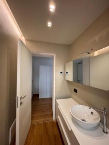 a bathroom with a sink and a mirror at Residenza la Torretta in Domodossola