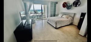 a bedroom with a bed and a view of the ocean at The Suites of Solymar in Cancún
