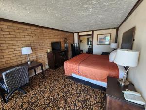 a hotel room with a bed and a desk at Carthage Inn in Carthage