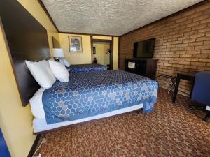 a hotel room with two beds and a television at Carthage Inn in Carthage