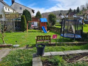 a yard with a bench and a playground at Husic Immobilien und Handwerkerservice in Rimbach